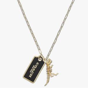 Coach Gold and Black Tag “Rexy” Skeleton Necklace